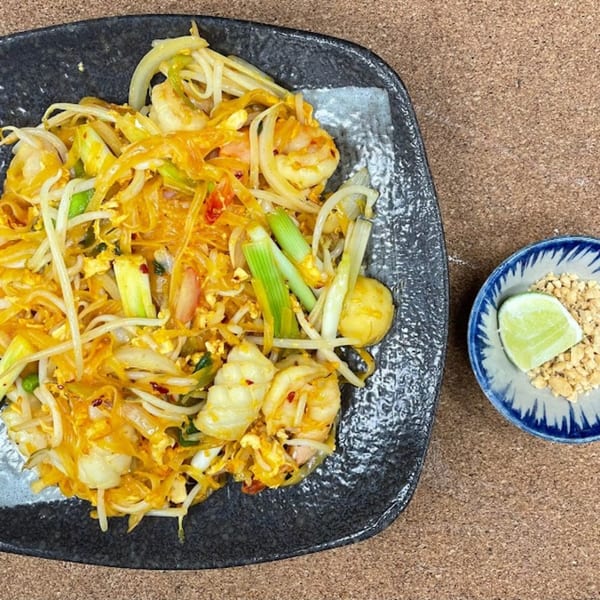 Vietnamese shrimp and noodle dish with vegetables, served with crushed peanuts and lime.